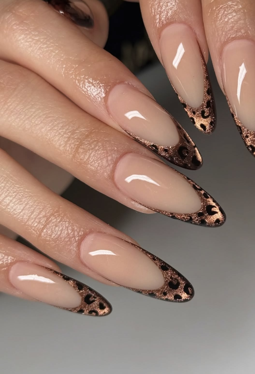 Long stiletto nails with copper-glitter leopard French tips on nude base