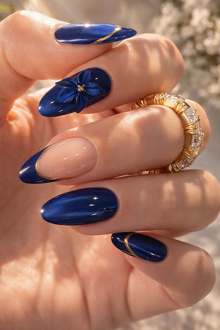 Sapphire blue nails with sculpted 3D flower and gold gilding accent