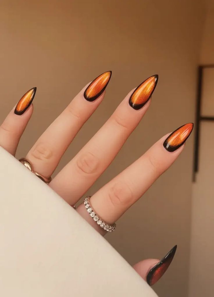 Orange amber jelly stiletto nails with black tips